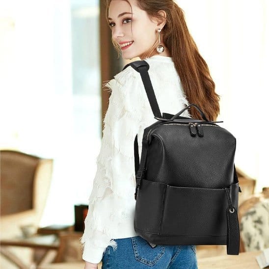 Jeune maman avec Sac à dos à langer noir sur les épaules